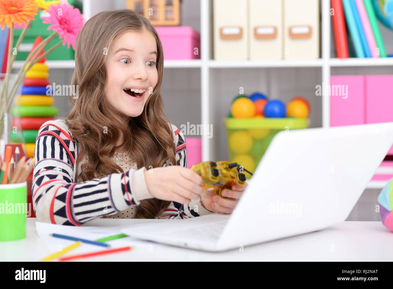 Portrait of little girl using modern laptop Stock Photo - Alamy