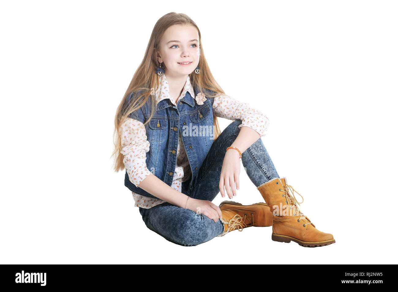 Happy little girl in jeans posing on white background Stock Photo Alamy