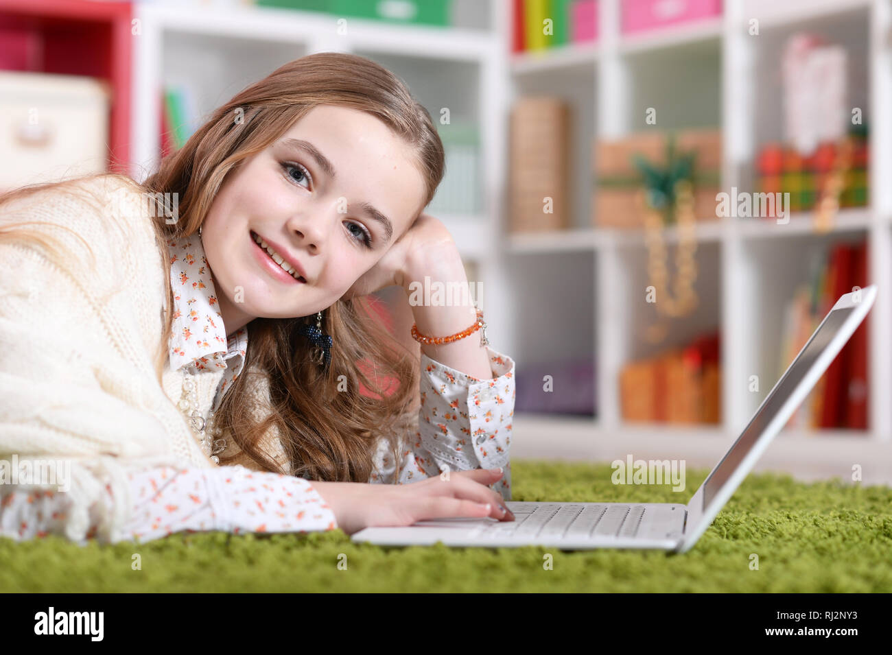Portrait of emotional cute girl using laptop Stock Photo - Alamy