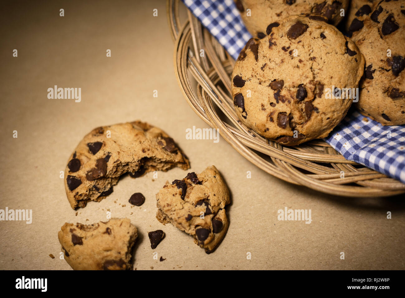 Chocolate chips cookies in a wooden basket . Food photography theme in vintage or retro color style. Stock Photo