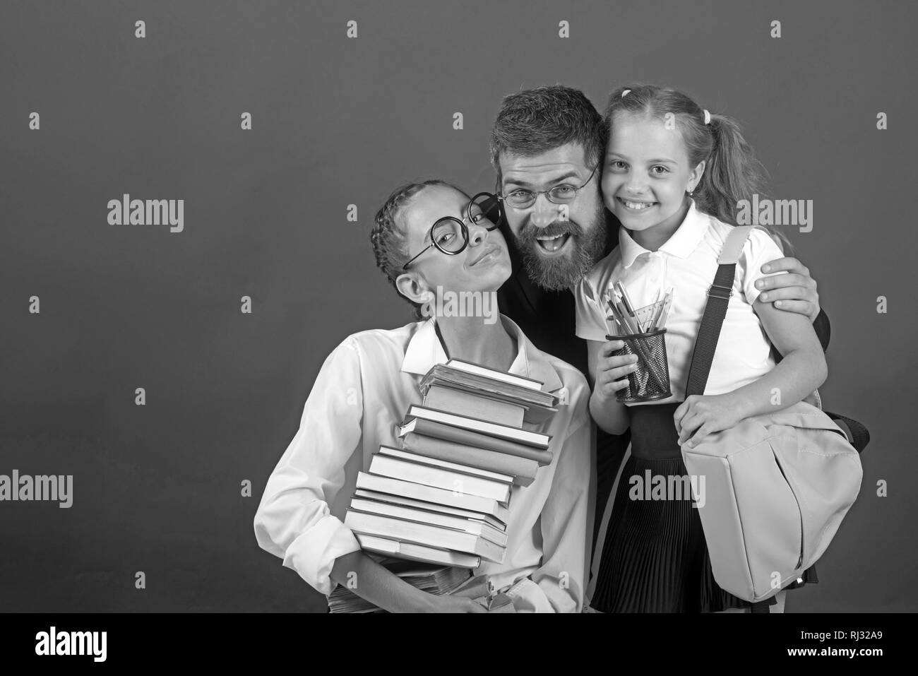 Young father with his daughter hold pile of books before going to school. Stock Photo
