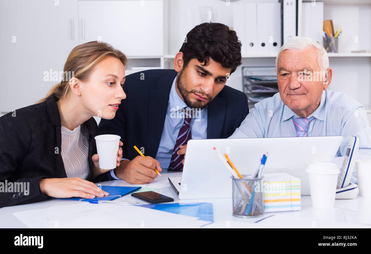 Managers are writing financial reports in the office. Stock Photo
