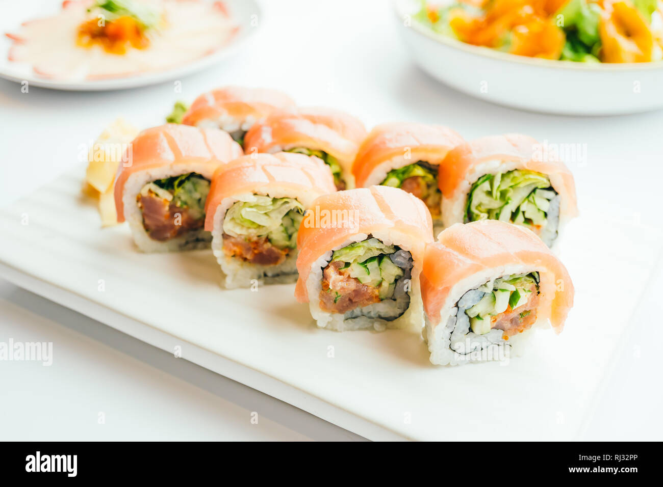 Raw fresh sushi roll with wasabi and soy sauce in white plate , Japanese food style - Color Filter Processing Stock Photo