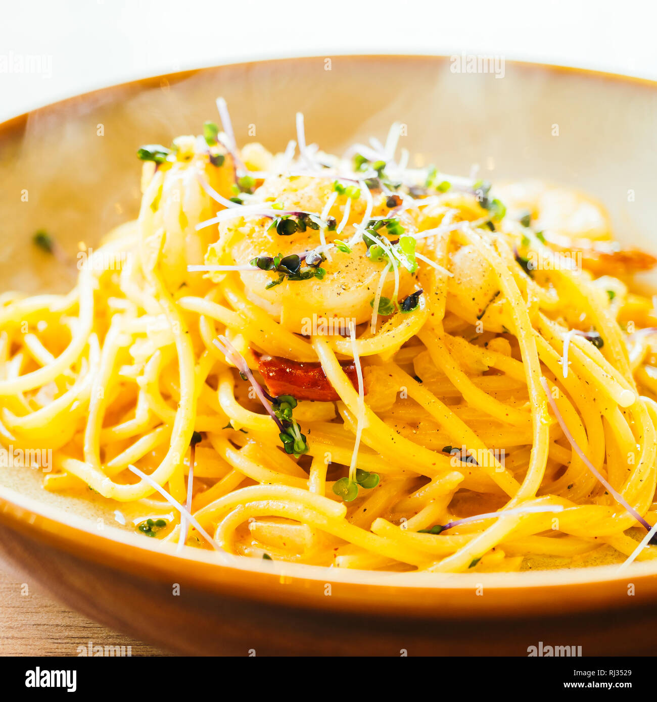 Spaghetti and pasta with prawn and sauce in plate - Color Filter Processing Stock Photo