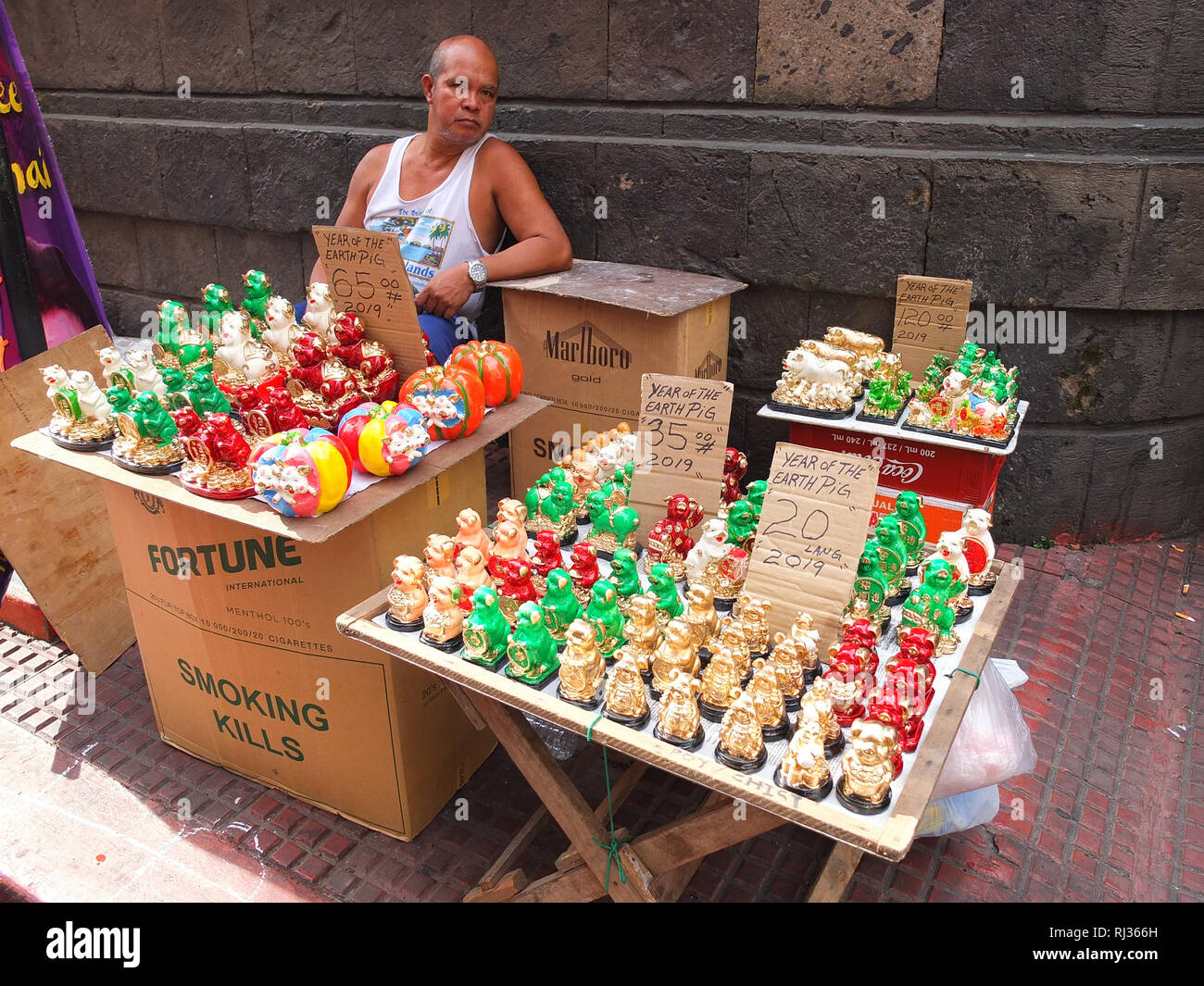 A man seen selling pig figurines and other lucky charms for good luck and  prosperity during the preparation. Filipino Chinese prepare for Chinese New  Year with their customs and traditions, in the