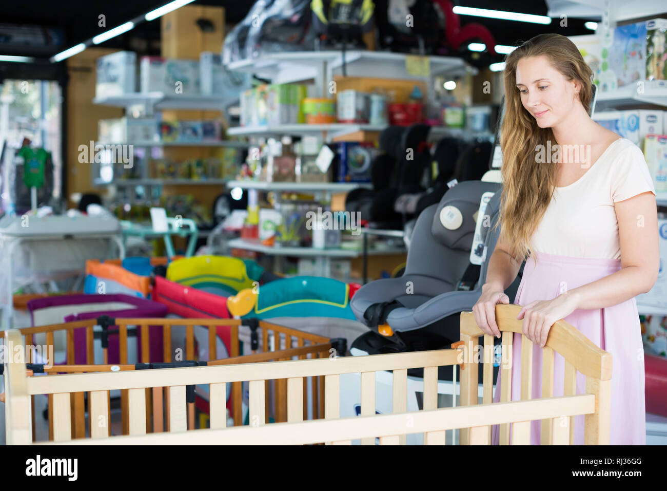 Happy Mother Buying Baby Crib At Kids Store Stock Photo 234869616