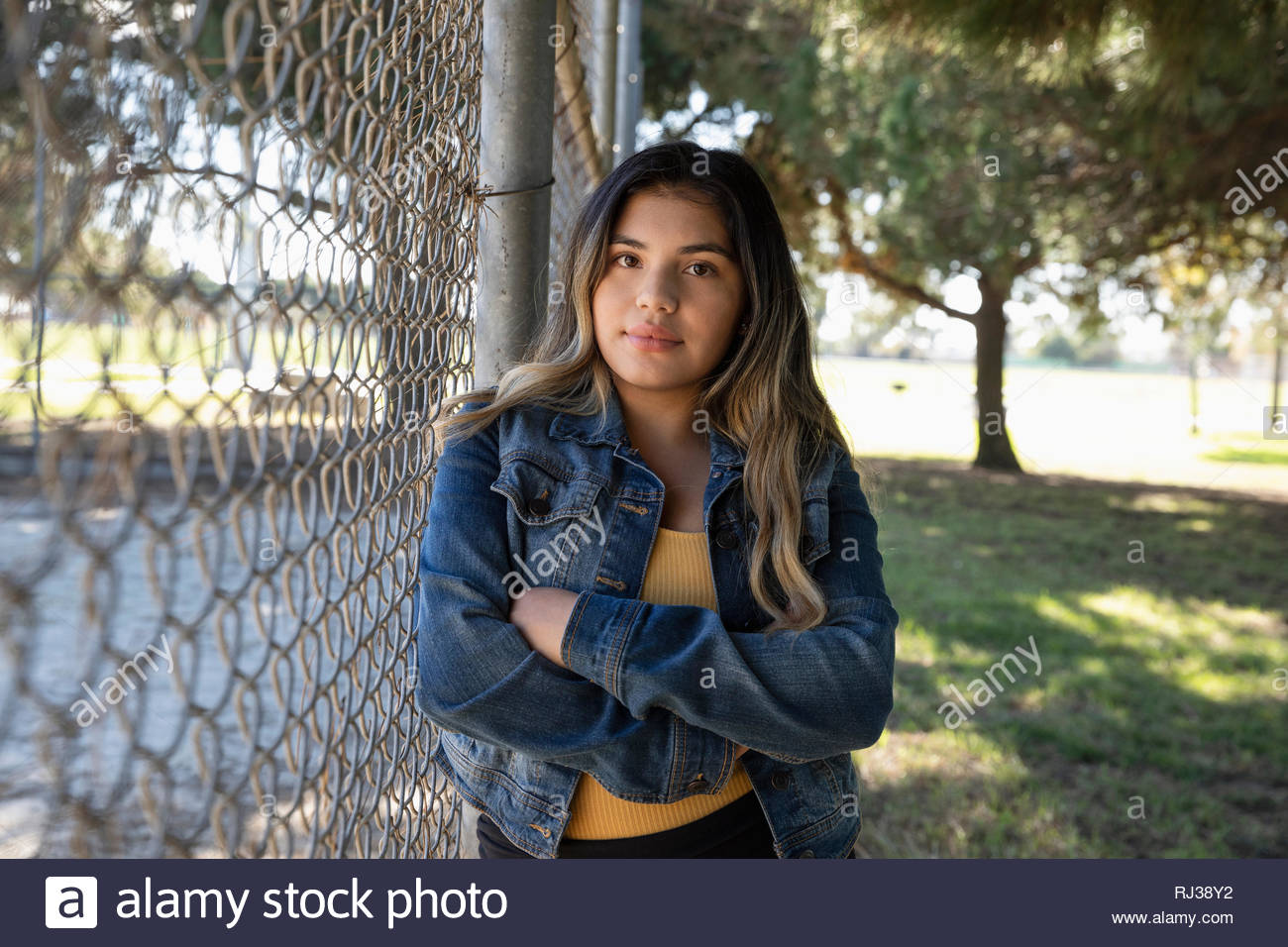 Hispanic fence standing hires stock photography and images