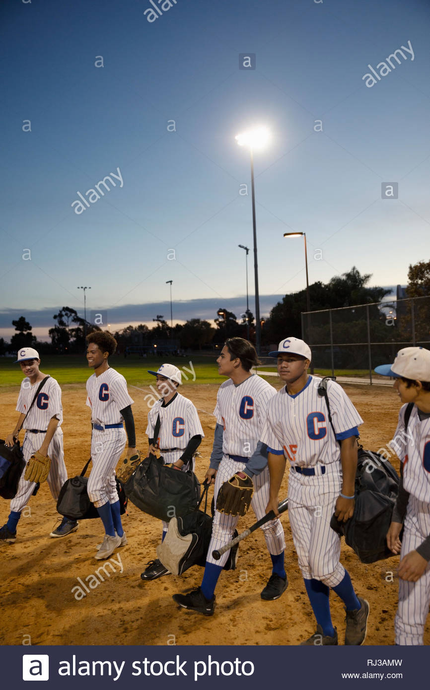 Baseball players walking off field at night Stock Photo Alamy