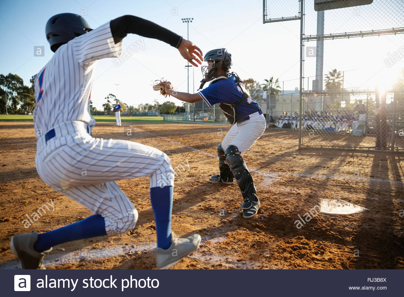 Baseball player sliding into home plate Stock Photo