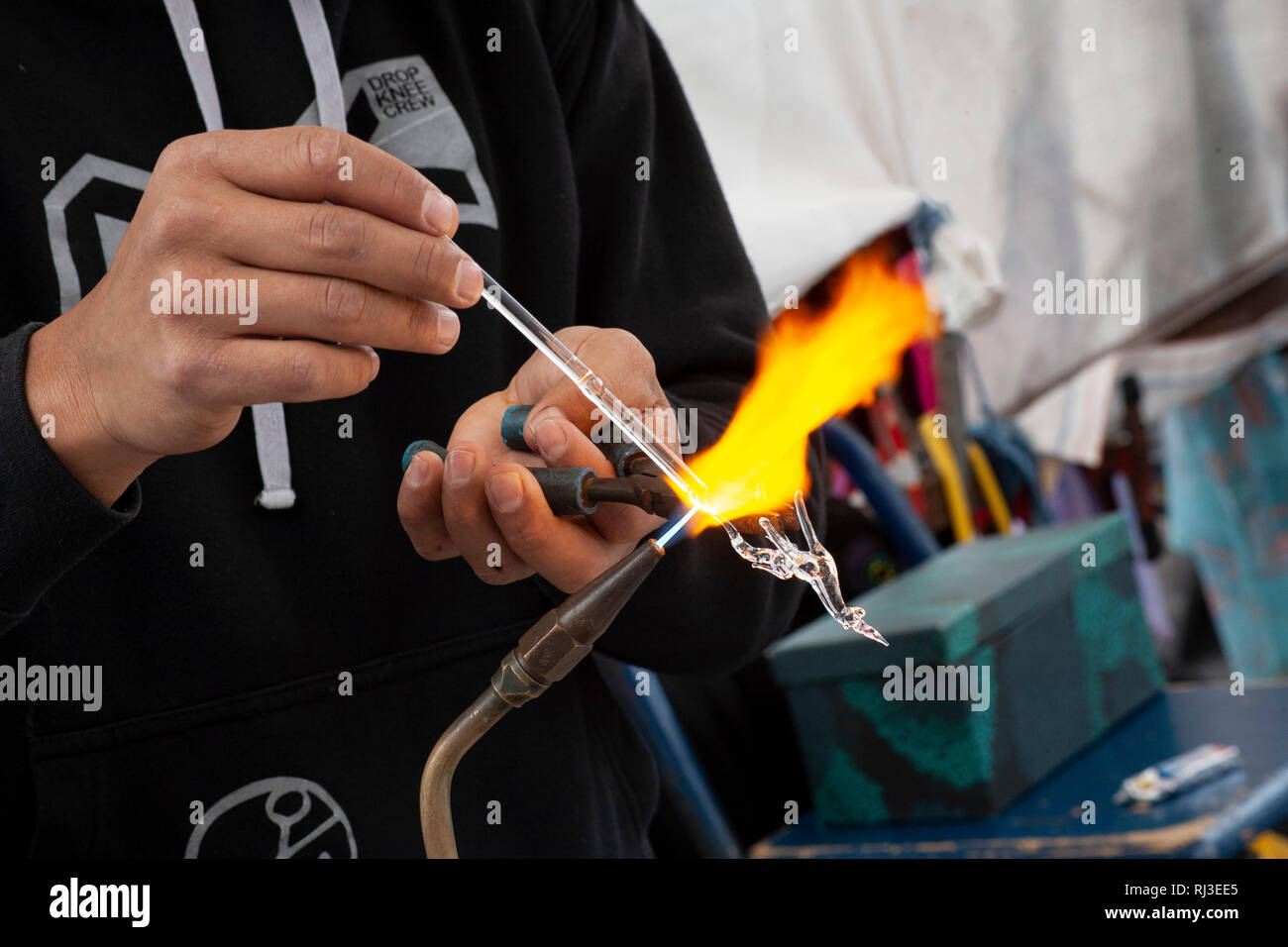 Man making glass sculpture - hand blown glass artistry Stock Photo