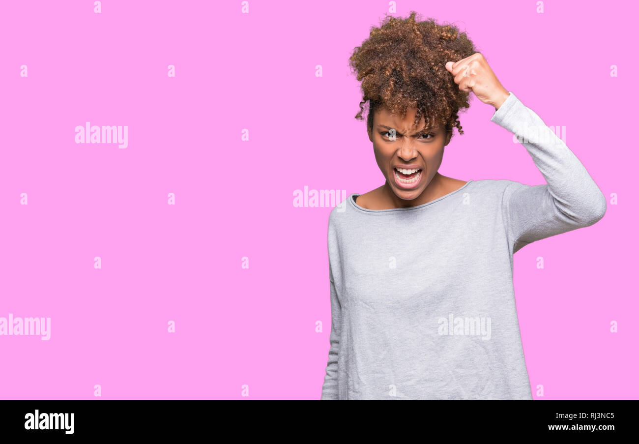 Angry young woman raising hand hi-res stock photography and images - Alamy