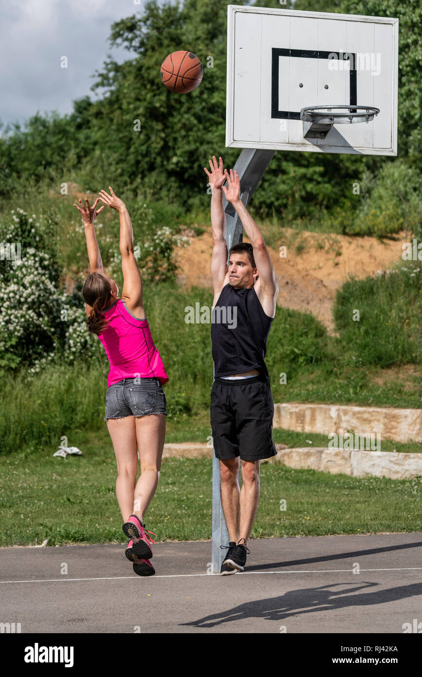 Young couple is playing basketball Stock Photo