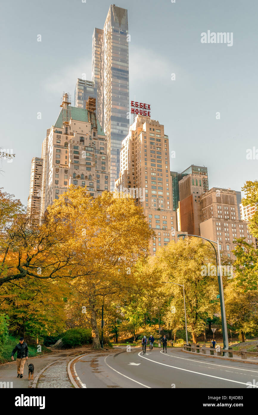 New York - October 31 2016: Colorful autumn day in Central Park New York with Essex House in the background. Stock Photo