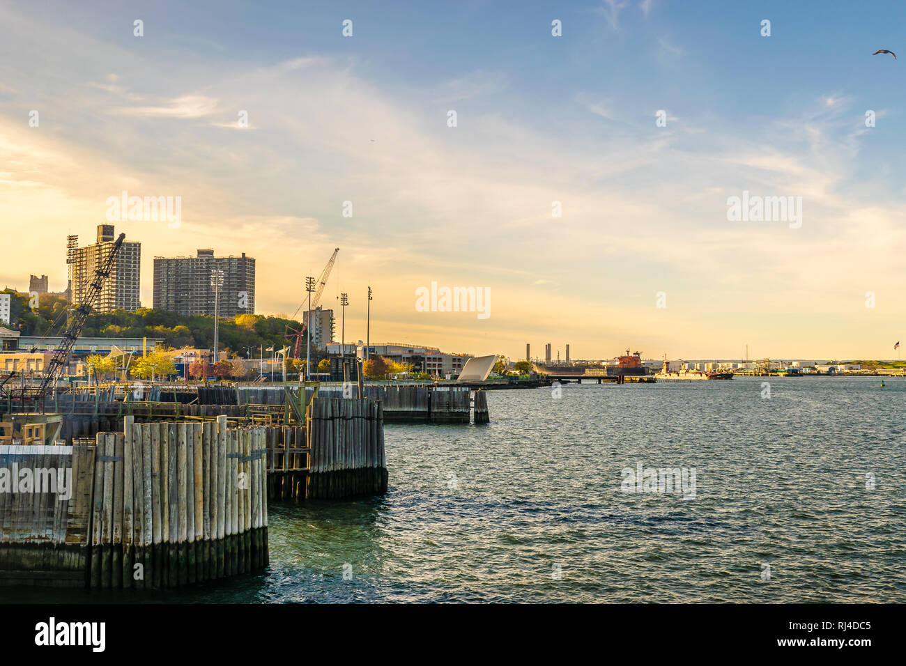 Staten Island Ferry Dock/Terminal in New York City with skyline of high rise buildings in the background. Stock Photo