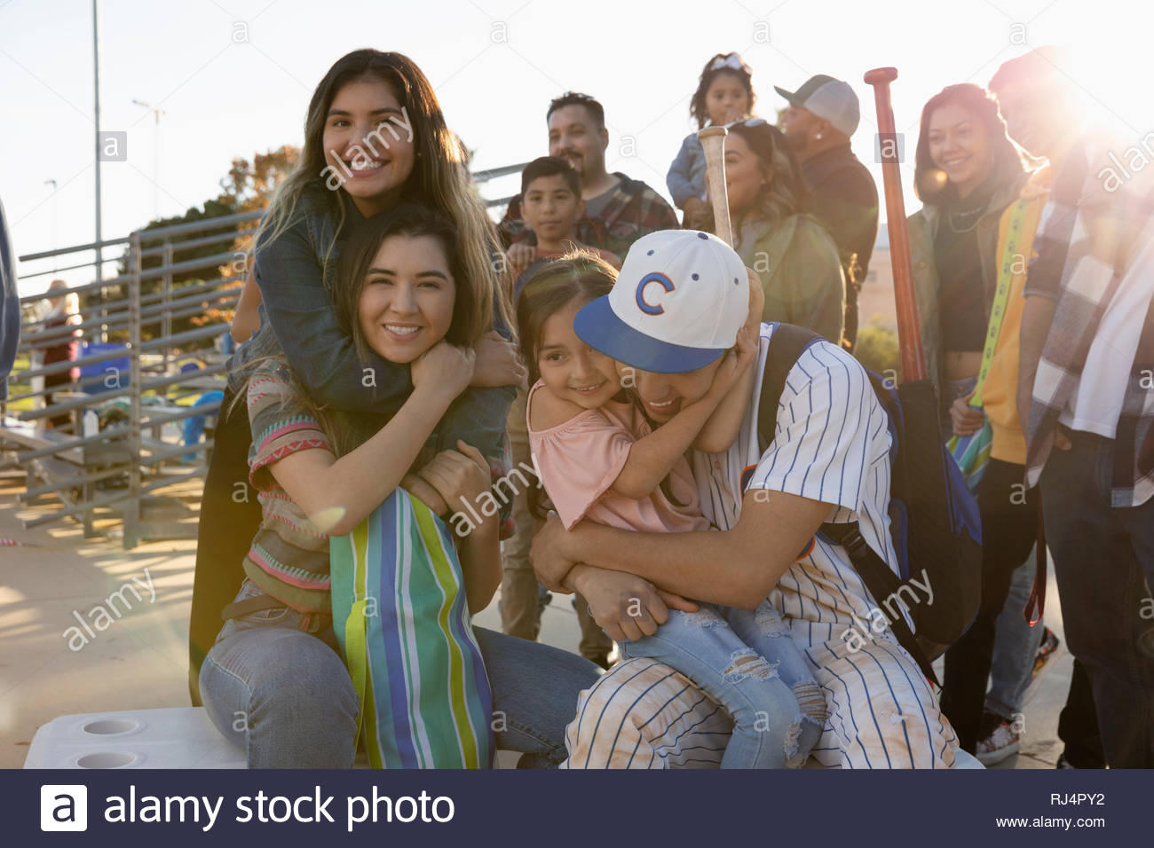Portrait happy Latinx baseball player and family Stock Photo