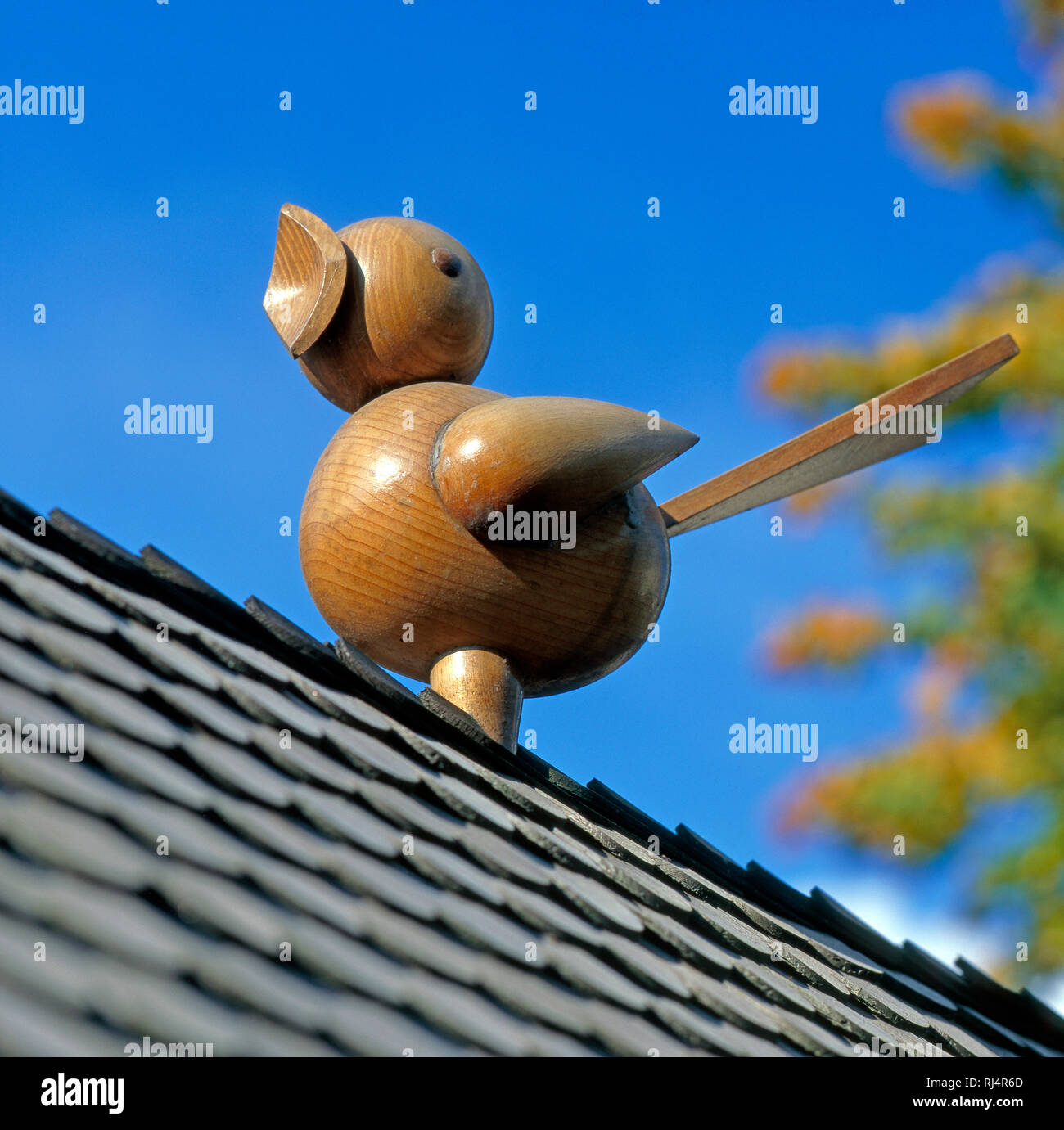 Aus Holz gedrechselter Singvogel als Schmuckelement im Garten, Stock Photo
