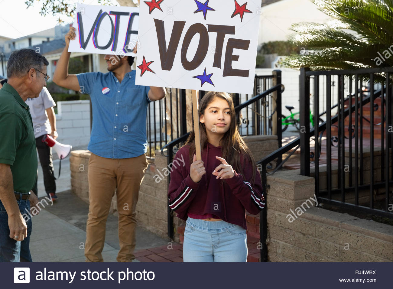 Latinx tween girl volunteering, canvassing voters Stock Photo