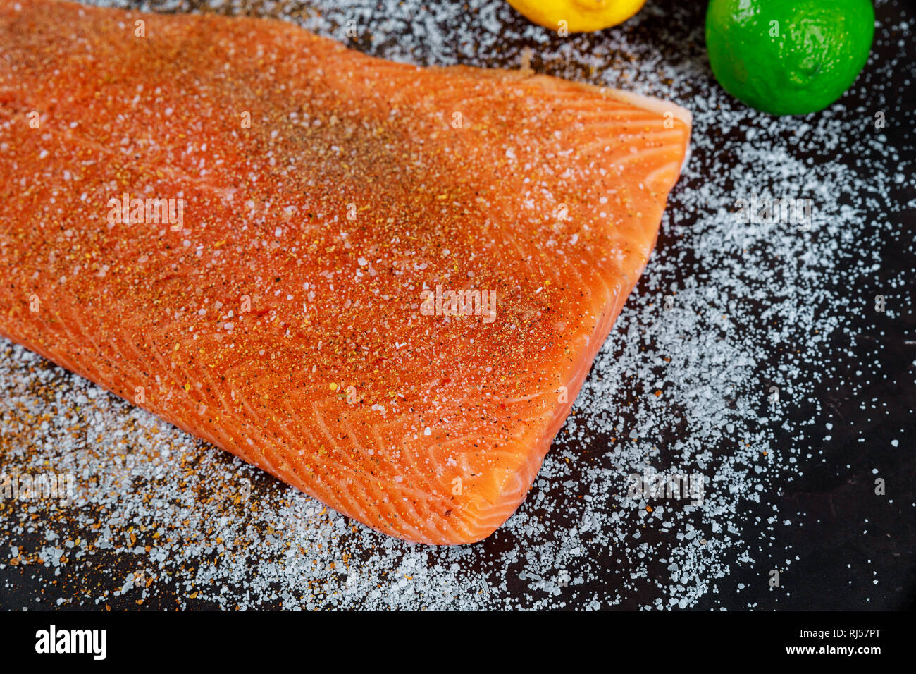 Salmon raw fillet marinated with spices, prepared for cooking Stock