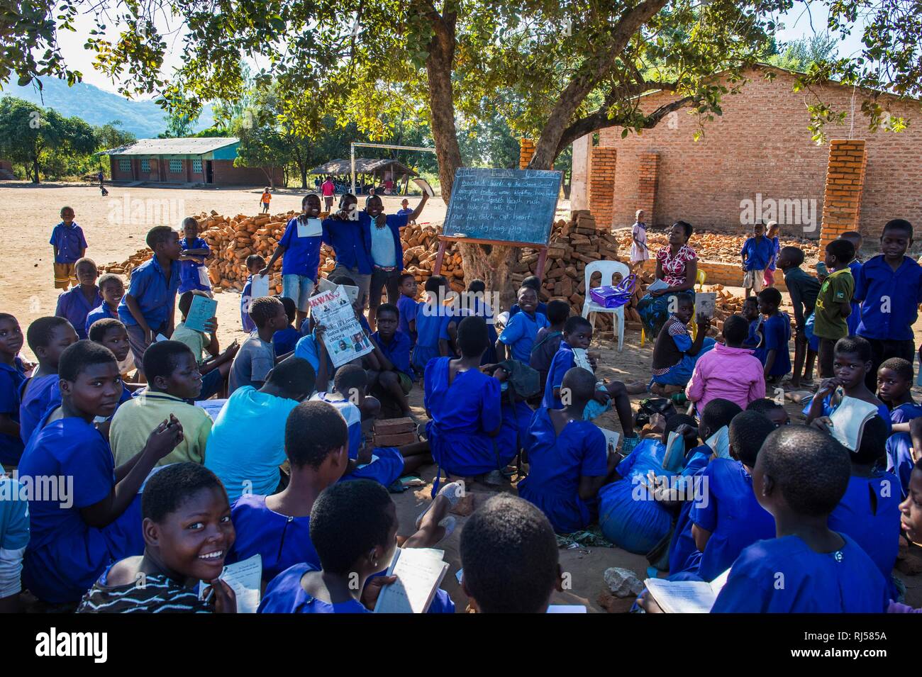 Primary school outside with many children, pupils in class uniform, Liwonde National Park, Malawi Stock Photo