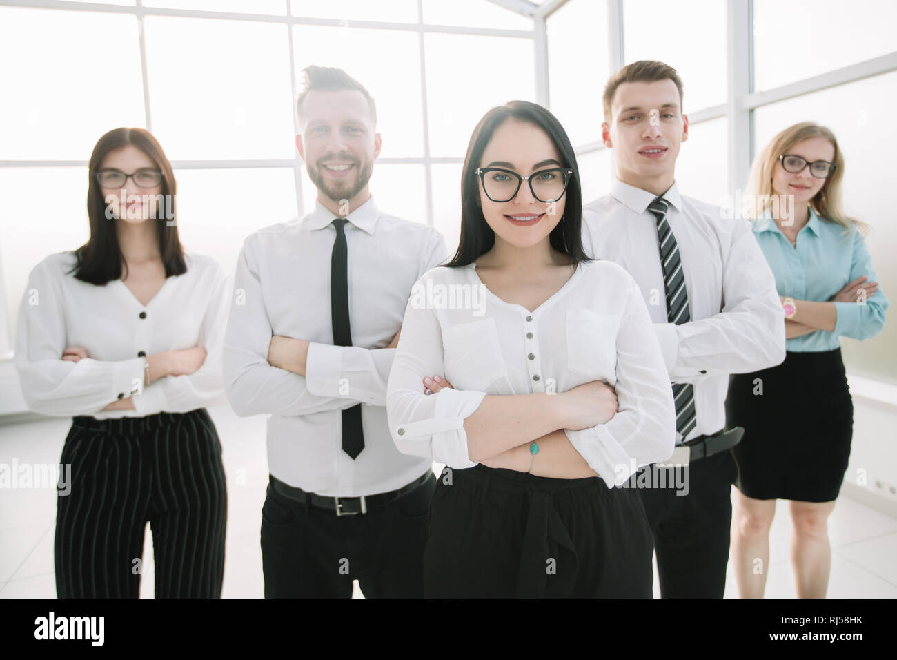 serious businesswoman and her business team standing together Stock ...