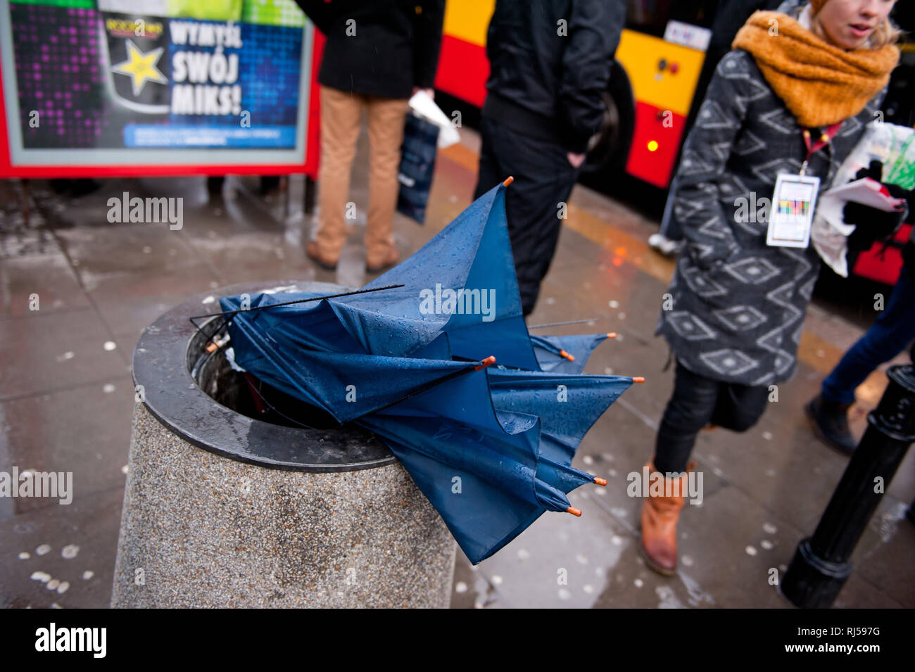 Broken umbrella in street tidy in rain, people waiting for bus in the day of 22nd GOCC Final day of The Grand Orchestra of Christmas Charity, Wielka O Stock Photo
