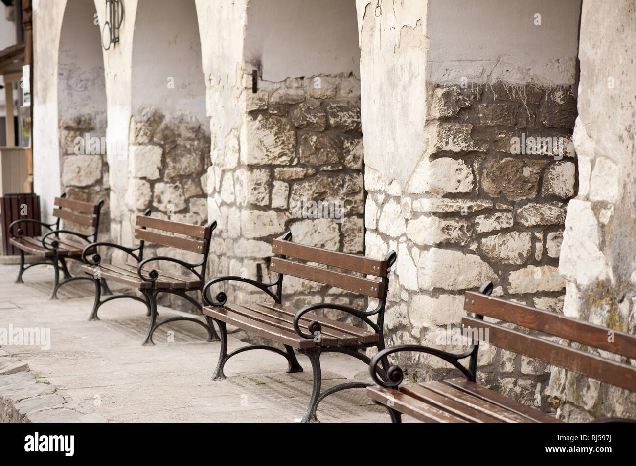 Calcareous and concrete columns and row of decorative benches in Kazimierz Dolny Rynek, 2013, Poland, Europe, Stock Photo
