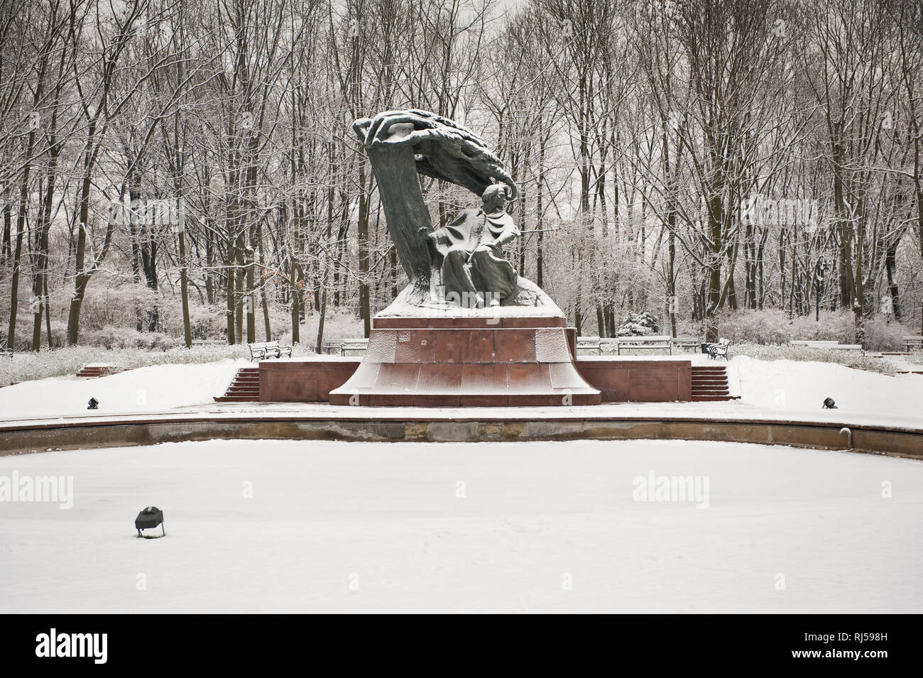 Fredric Chopin statue in Royal Baths Park in Warsaw, snowy weather in Polish Lazienki Krolewskie, Poland, Europe, Stock Photo