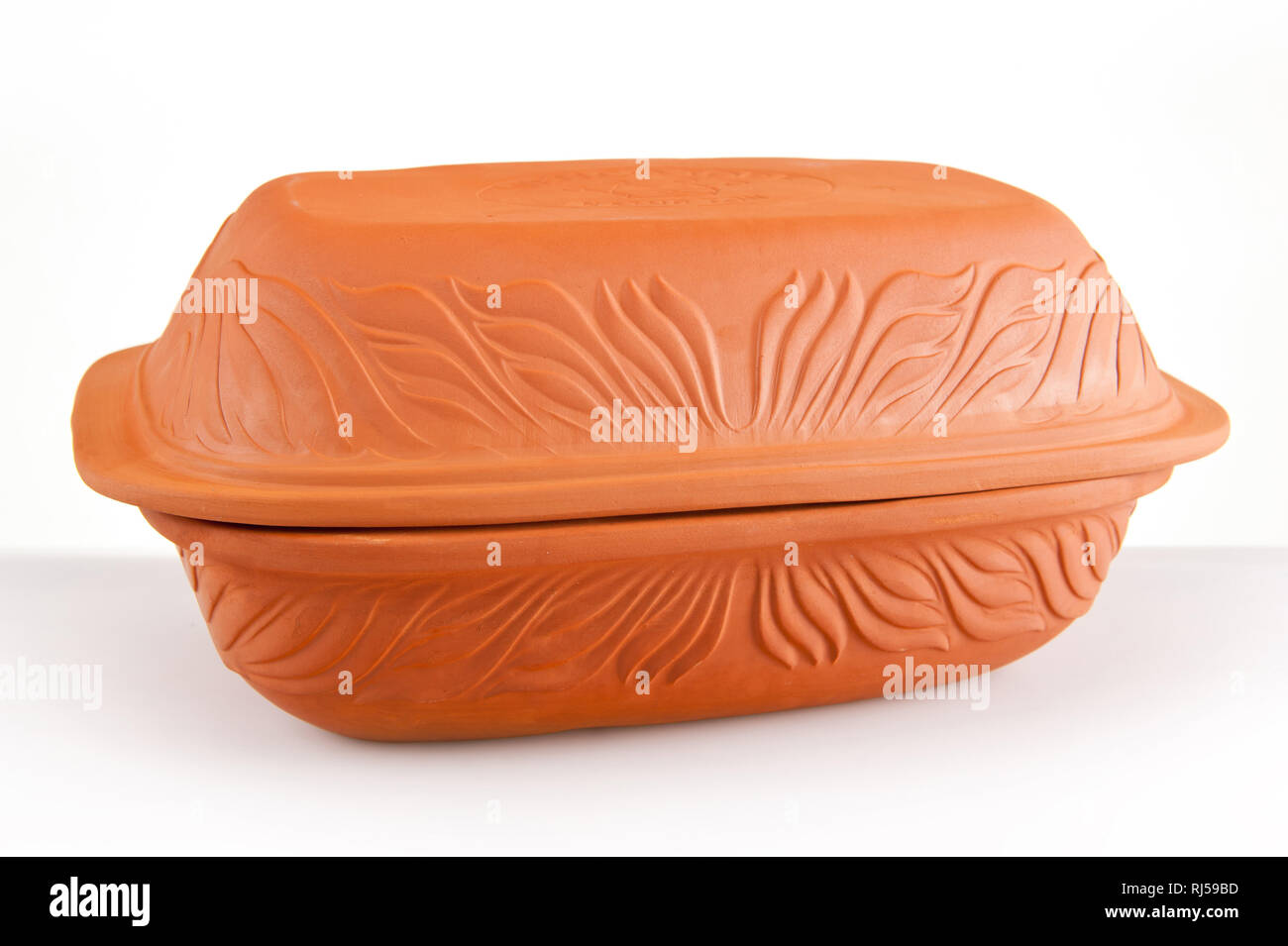 Roman dish clay baker, cooker porous clay pot, traditional roasting vessel  on white background, horizontal, nobody Stock Photo - Alamy