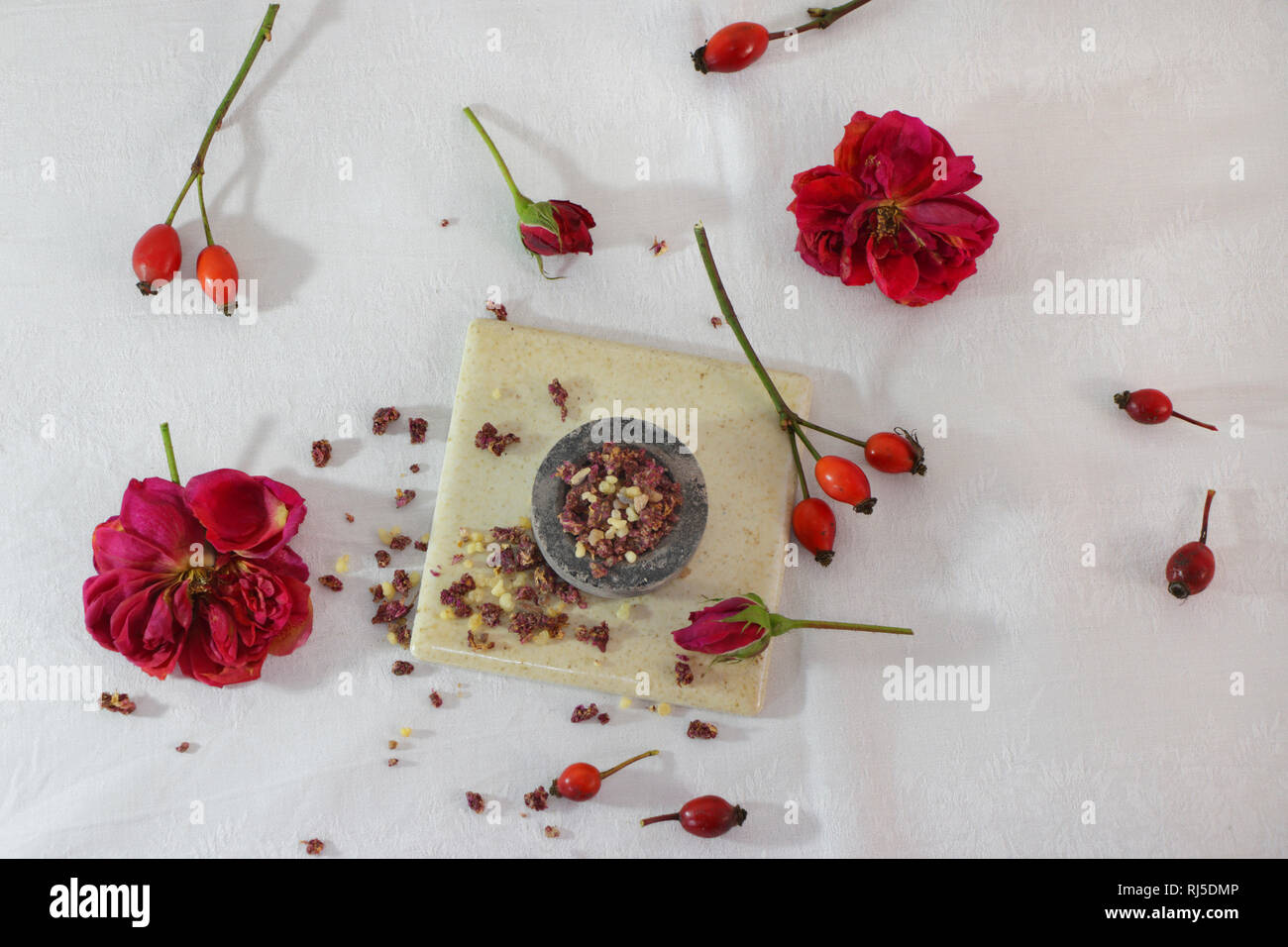 Weihrauch, getrocknete Rosenblüten, Hagebutten und Räucherkohle Stock Photo