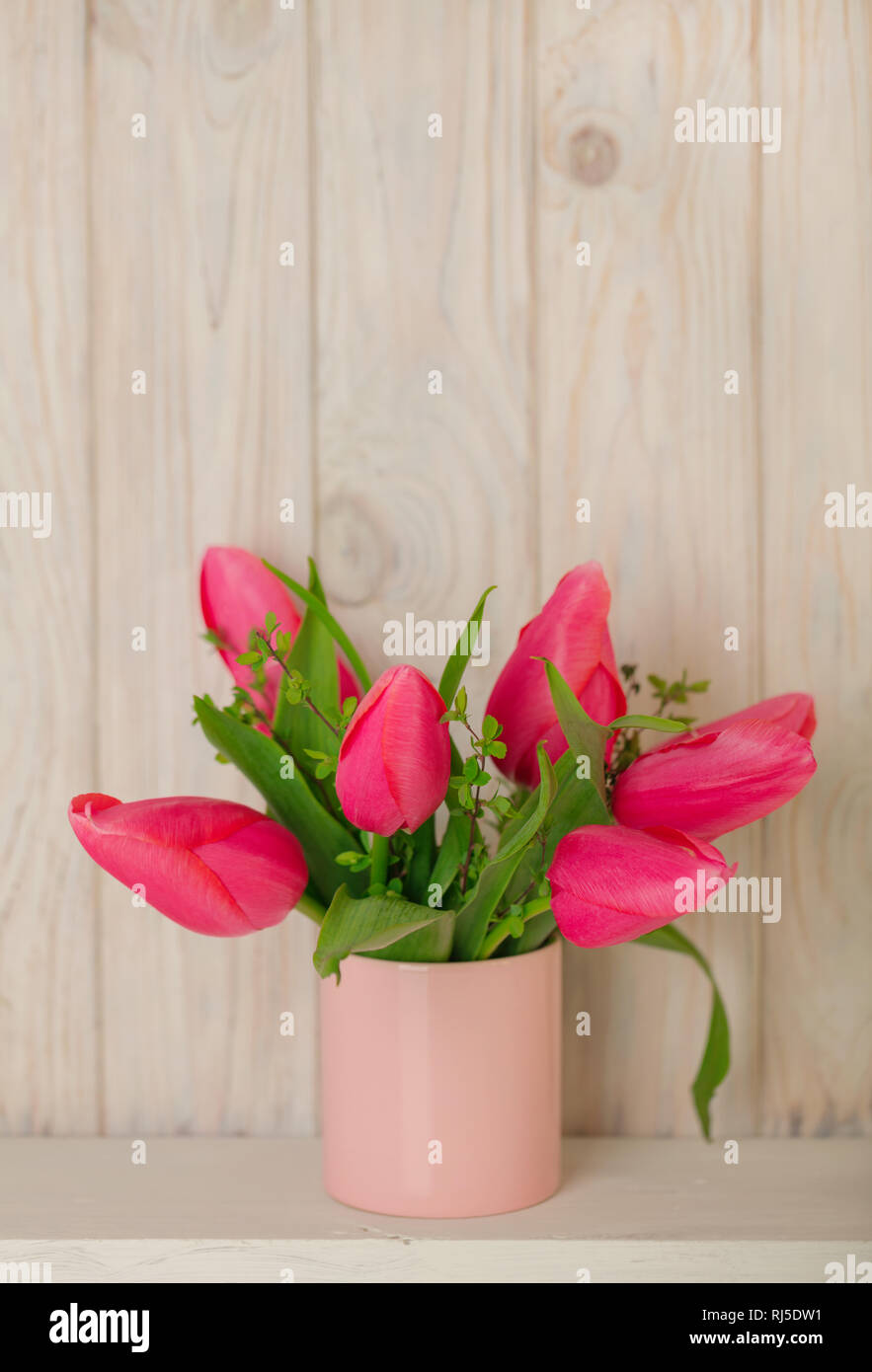 Spring bouquet of pink tulips with branches of a blossoming tree on a ...