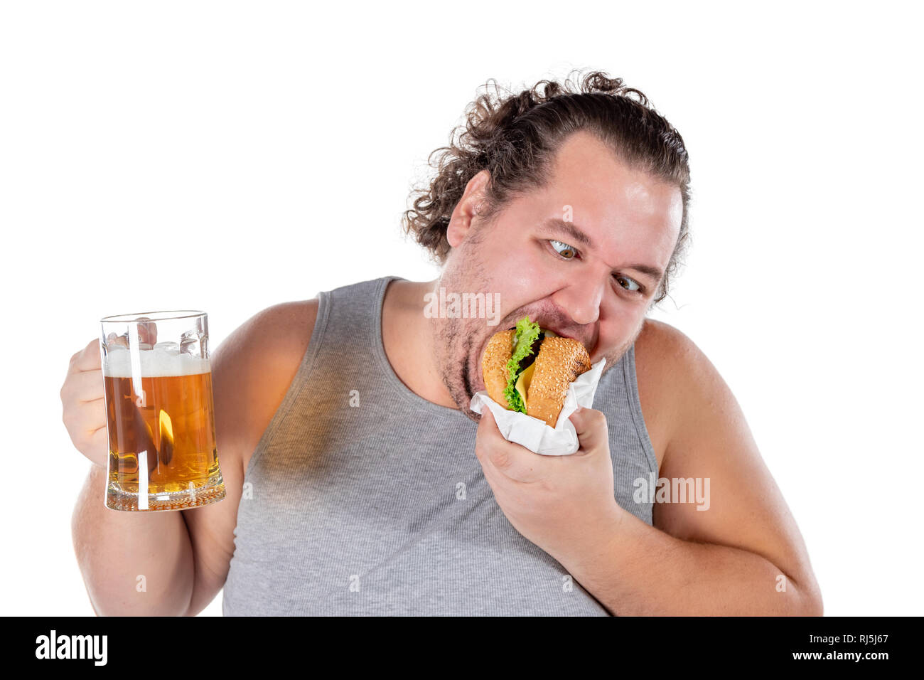 Funny fat man eating burger and drinking alcohol beverage Stock Photo