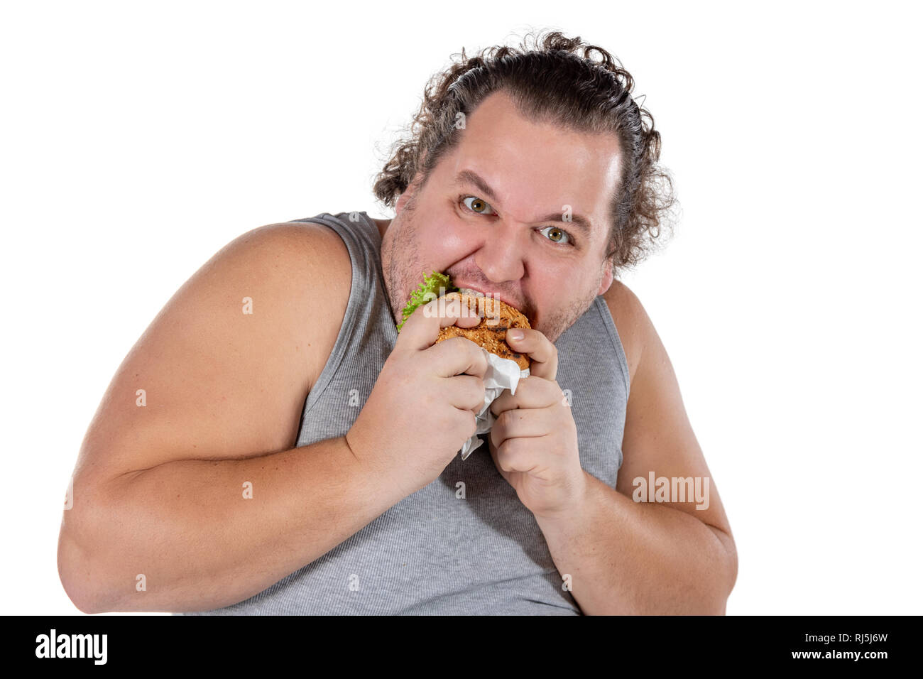 Portrait of funny fat man eating fast food burger isolated Stock Photo ...