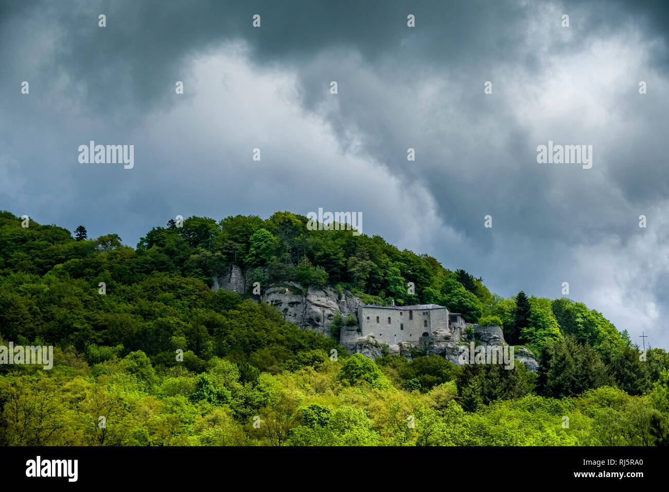 The monastery Santuario della Verna is located on a forested hill Stock Photo
