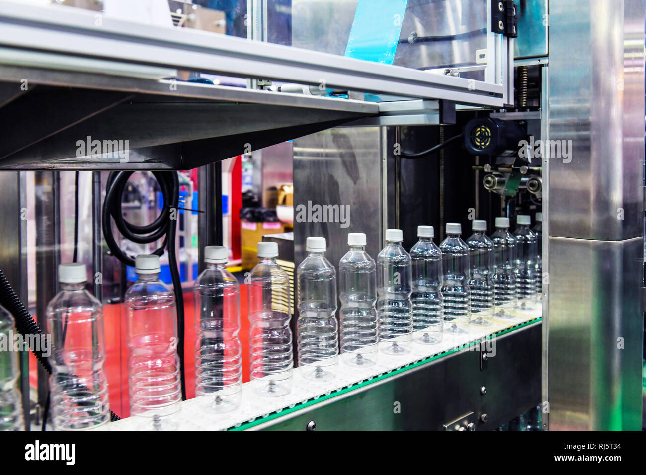 Clear Bottles transfer on Automated conveyor systems industrial automation for package Stock Photo