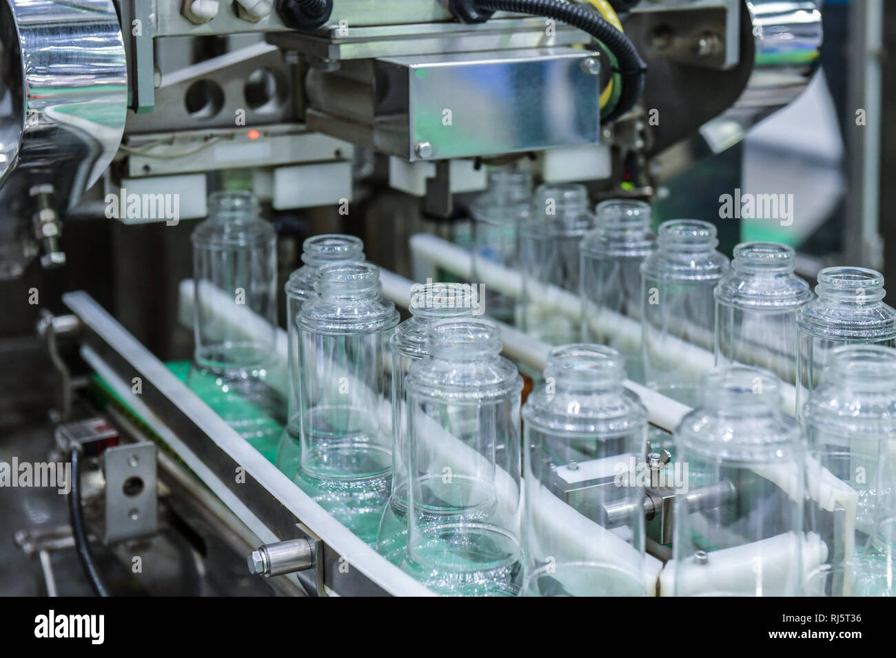 Clear Glass bottles transfer on Automated conveyor systems industrial