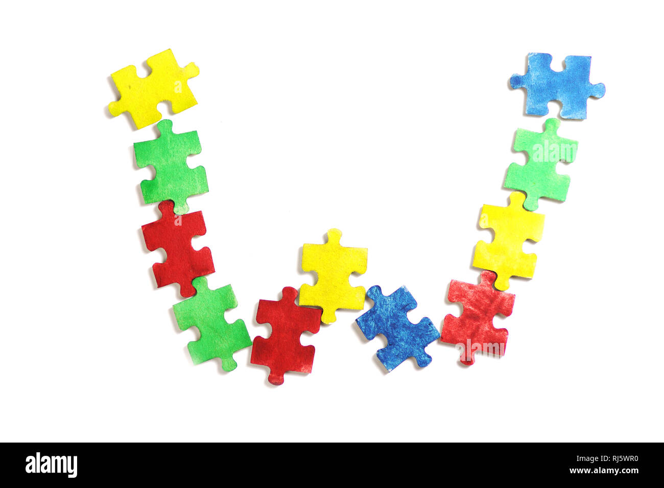 Colourful jigsaw puzzle and alphabet tiles with AUTISM word. Autism concept Stock Photo