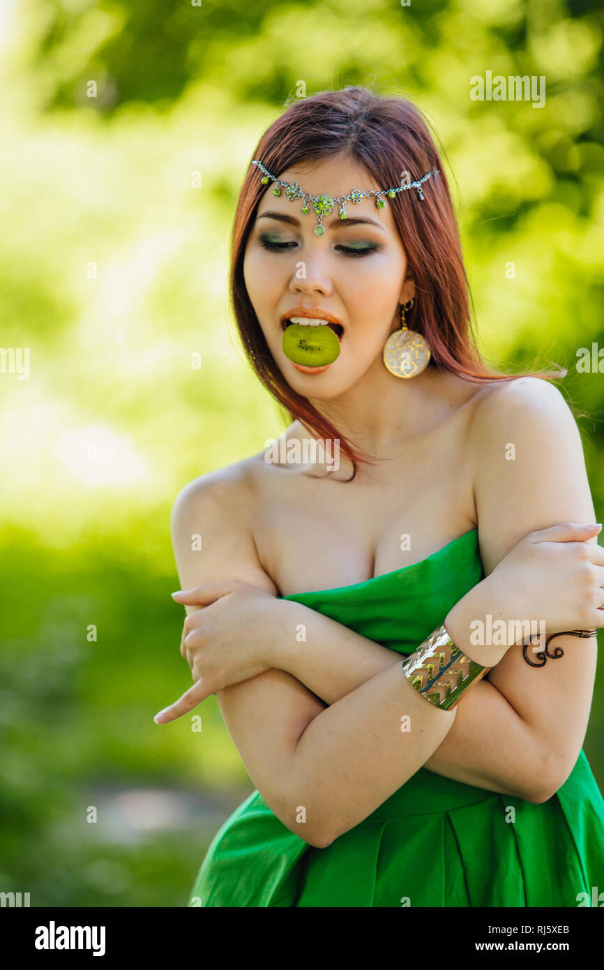 Portrait of a beautiful young asian woman in green dress and diadema on ...