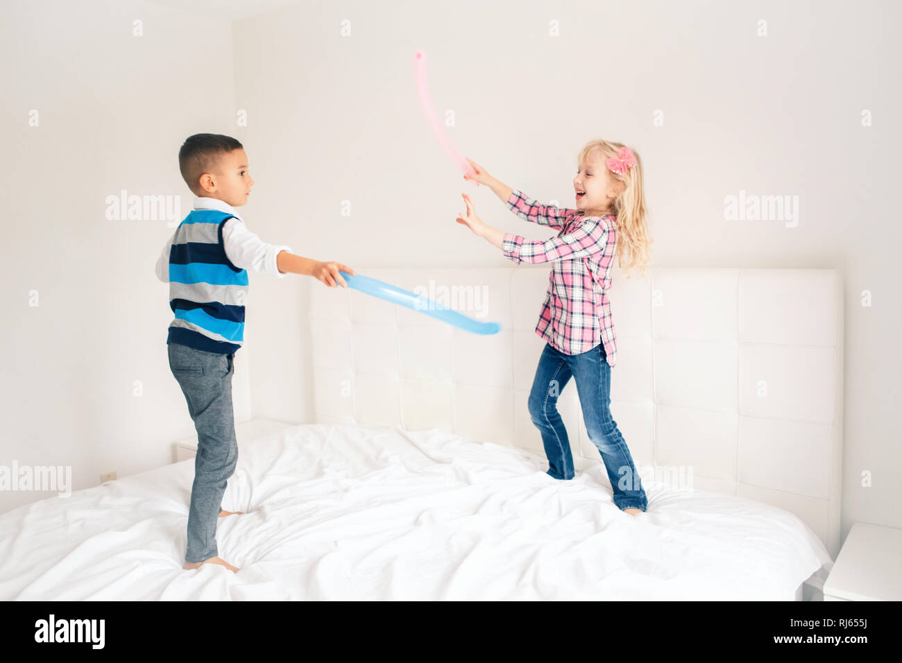 Two Caucasian Cute Adorable Funny Children Jumping On Bed In Bedroom And Playing Boy And Girl Are Having Fun Fighting With Balloons Best Friends For Stock Photo Alamy Two Caucasian Cute Adorable Funny Children Jumping On Bed In Bedroom And Playing Boy And Girl Are Having Fun Fighting With Balloons Best Friends For Stock Photo Alamy