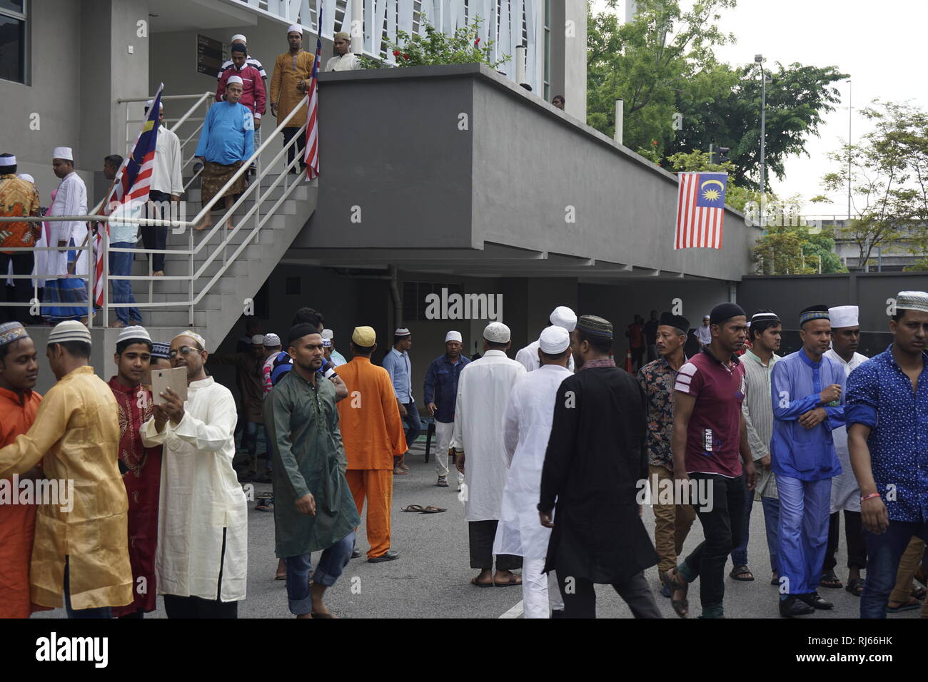 Muslim immigrant workers after prayers  at mosque in Kuala Lumpur, Malaysia Stock Photo