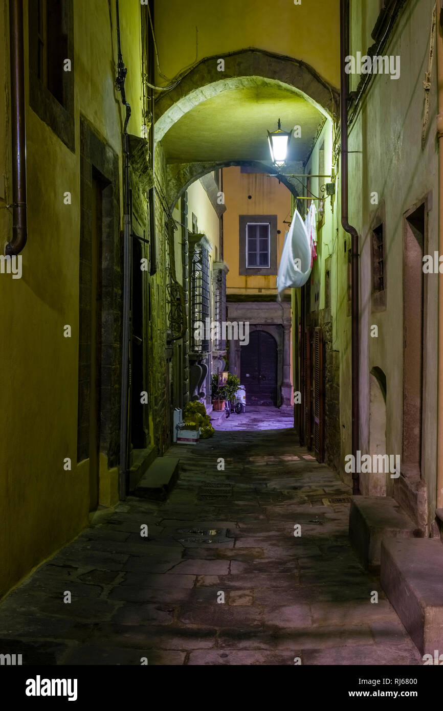 View on a small street and houses of the medieval town, illuminated at ...