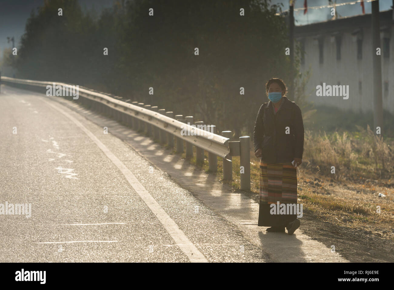 Tibet, Frau mit Mundschutz am Friendship Highway Stock Photo