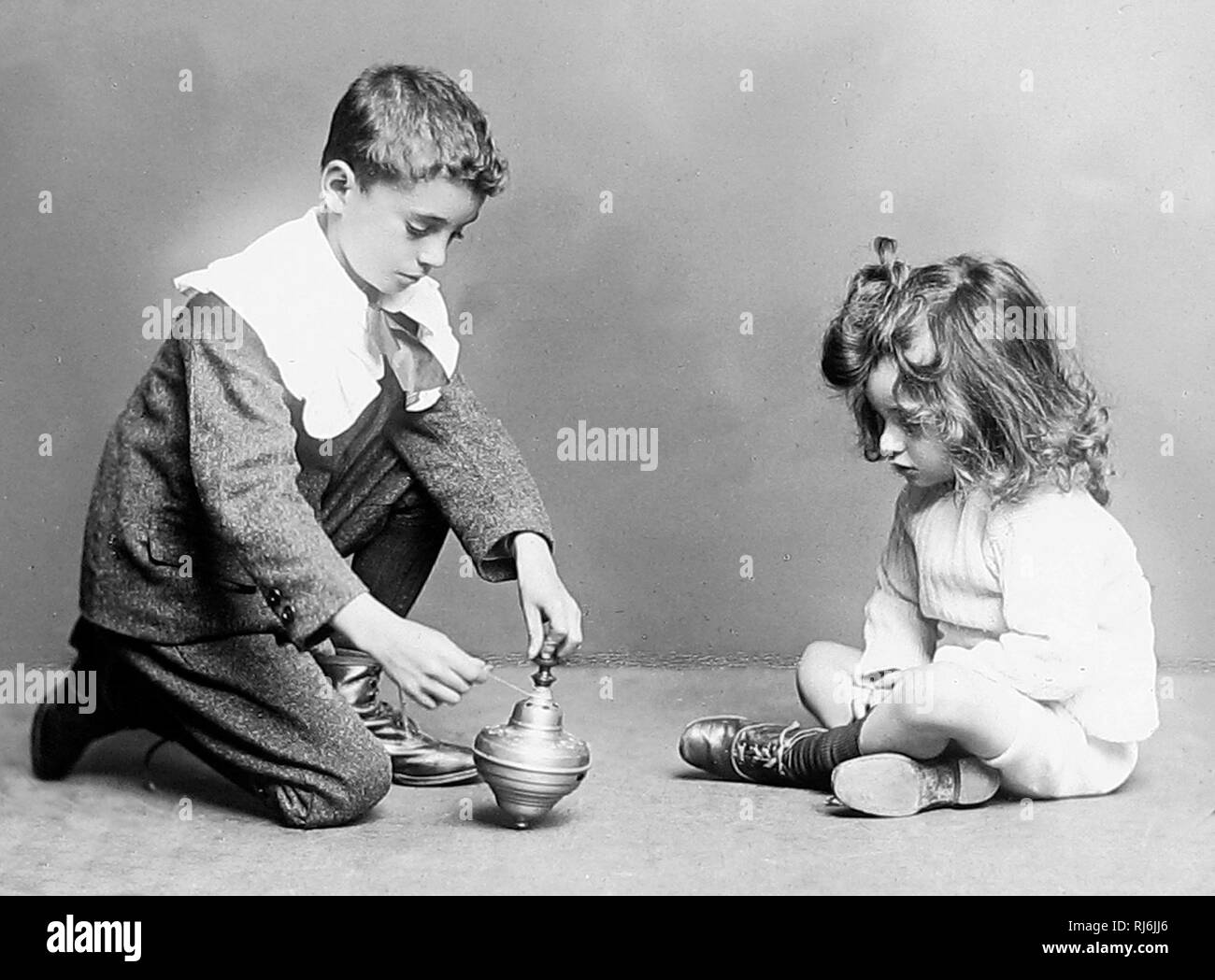 Children playing with spinning top Stock Photo Alamy