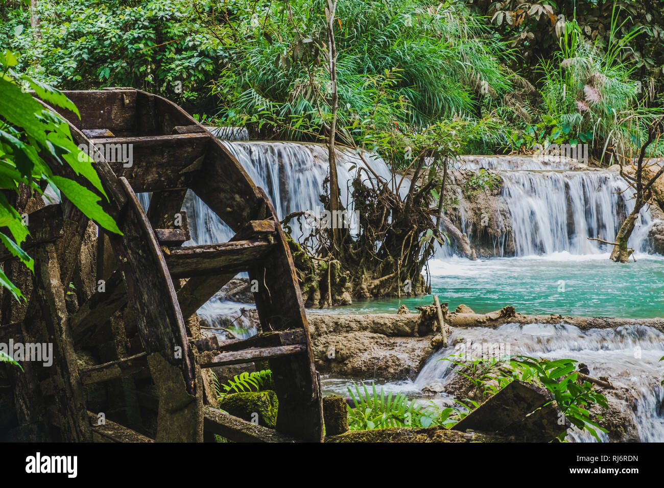 Kuang Si water falls with an old water wheel,Laos Stock Photo