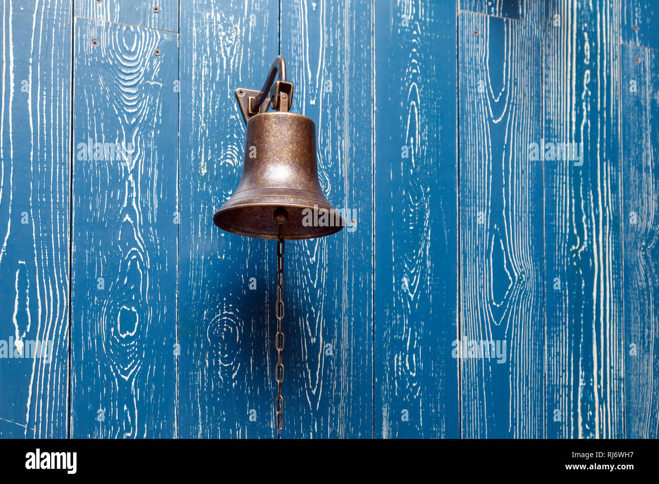 Copper Old Vintage Bell Doorbell Rope On A Wooden Blue Aged Wall