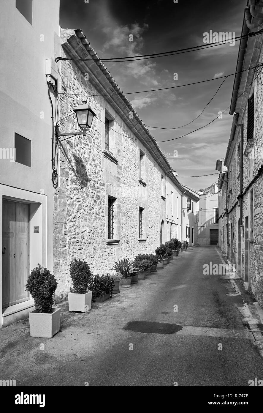 Black and white picture of an empty street in Alcudia old town, Mallorca, Spain. Stock Photo