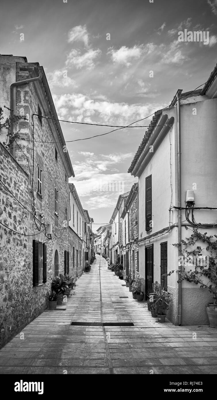 Black and white picture of a narrow street in Alcudia old town, Mallorca, Spain. Stock Photo