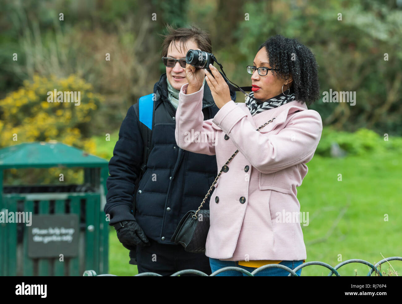 Mixed race couple of tourists taking photos of landmarks in the UK. Stock Photo