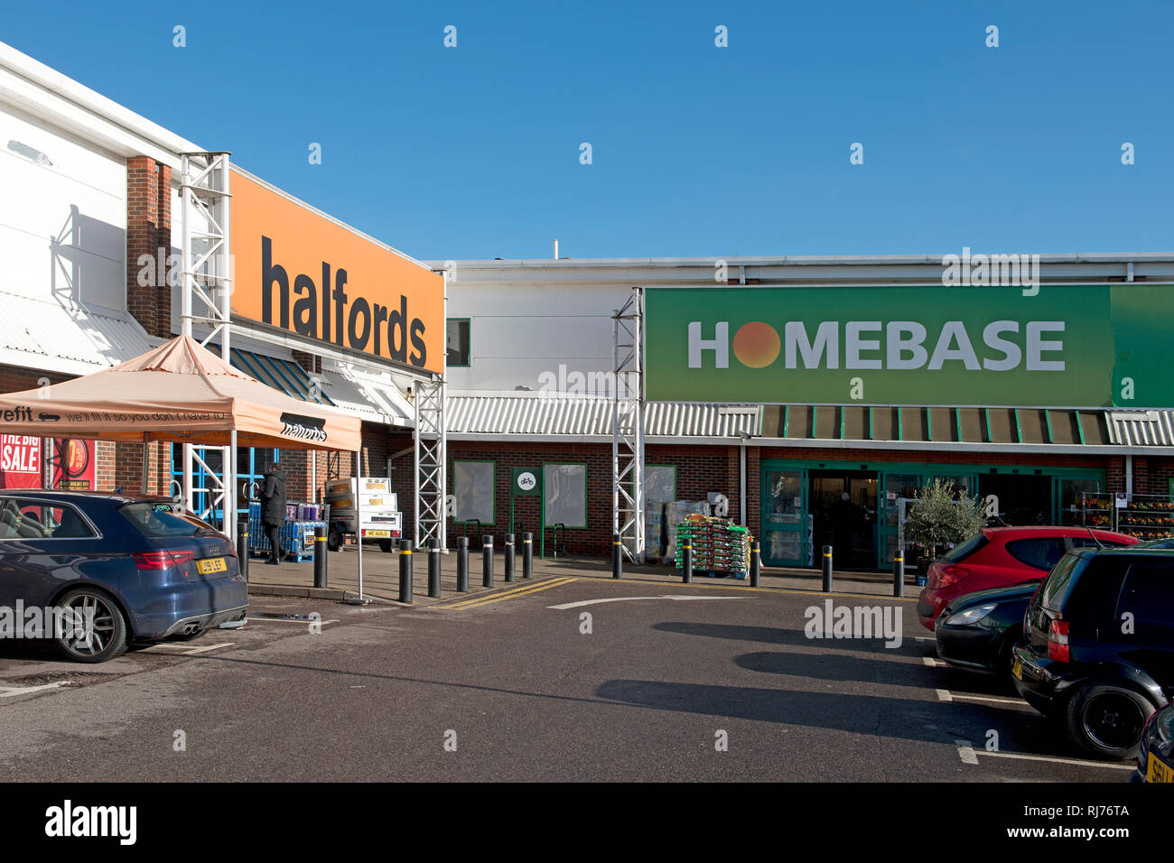 A Halfords store in Otford, Kent, selling autocare and cycling supplies Next to it is a DIY outlet selling home improvement supplies Stock Photo