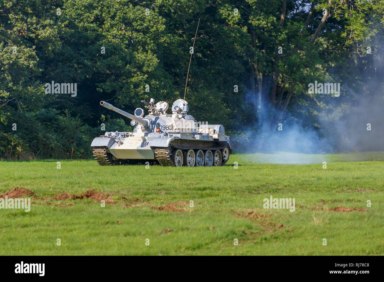 T55A battle tank in motion and emitting smoke, ex Slovakian army reserve, in Peruvian army colour scheme, on display for rides at an airshow display Stock Photo