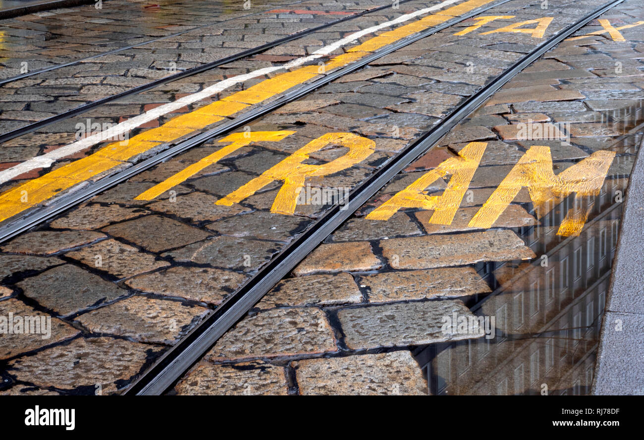 Cobbled road in central Milan showing lane markings for Tram and taxi, Milan, Lombardy, Italy. Stock Photo